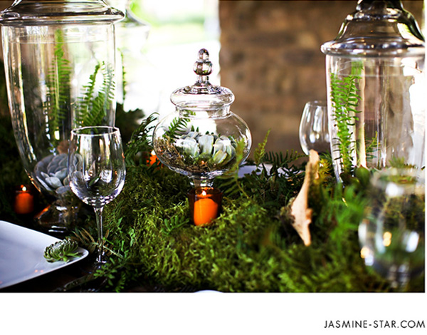 Apothecary jars moss ferns succulants a few twigs and votive candles 